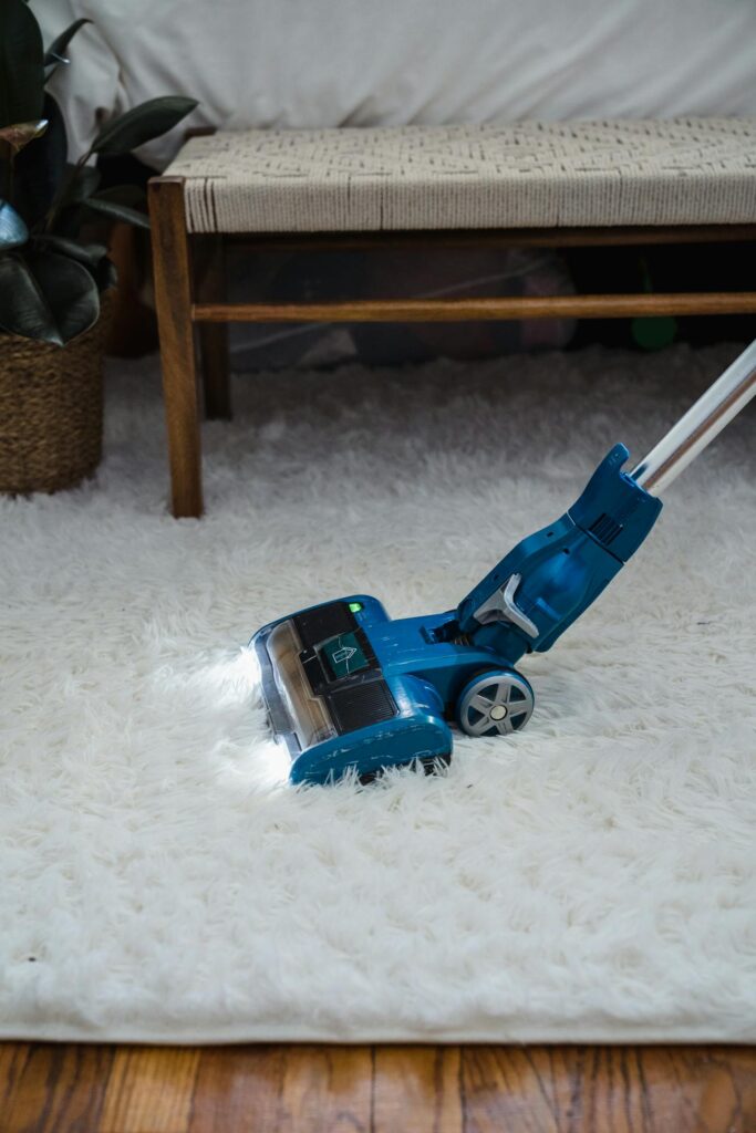 Home Blue Vacuum Cleaner on White Fur Carpet