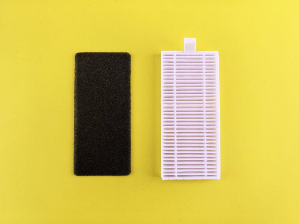 Black foam and white air filter on yellow background