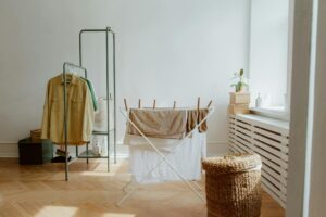 A laundry room with natural light and organized clothes drying setup.