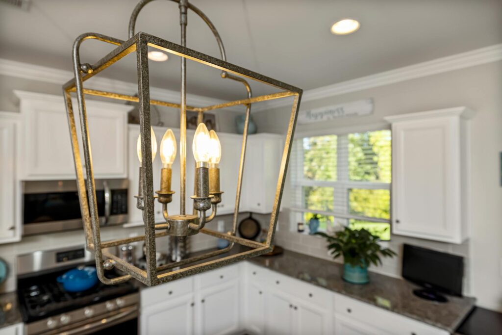 How to Clean Light Fixtures and Lamps Close-up of a stylish vintage chandelier in a contemporary kitchen setting.