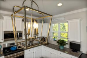 Close-up of a stylish vintage chandelier in a contemporary kitchen setting.