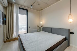 How to Clean a Mattress and Remove Odors Minimalist bedroom featuring modern furnishings and stylish lighting, ideal for contemporary living.