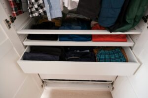 How to Organize a Linen Closet IKEA PAX Wardrobe, ikea white pax wardrobe, minimal shirts lined up with drawers, colorful t-shirts, ikea bedroom cabinets.