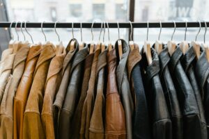 How to Wash Jackets and Coats A collection of leather and suede jackets hanging on a clothes rack in a stylish boutique.