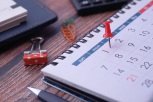 How to Build a Home Cleaning Schedule Desk elements like calendar and pins for effective planning.