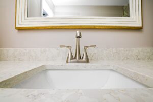 How to Re-Caulk a Bathtub or Sink Elegant bathroom sink with a minimalist faucet and mirror setup.