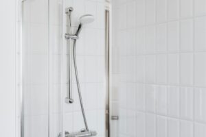 How to Replace a Showerhead Stylish shower setup with chrome fixtures and clean white tiles.