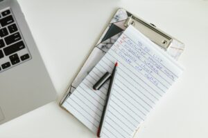 How to Create a Home Safety Checklist A neatly organized to-do list on a clipboard next to a laptop and pen, conveying productivity.